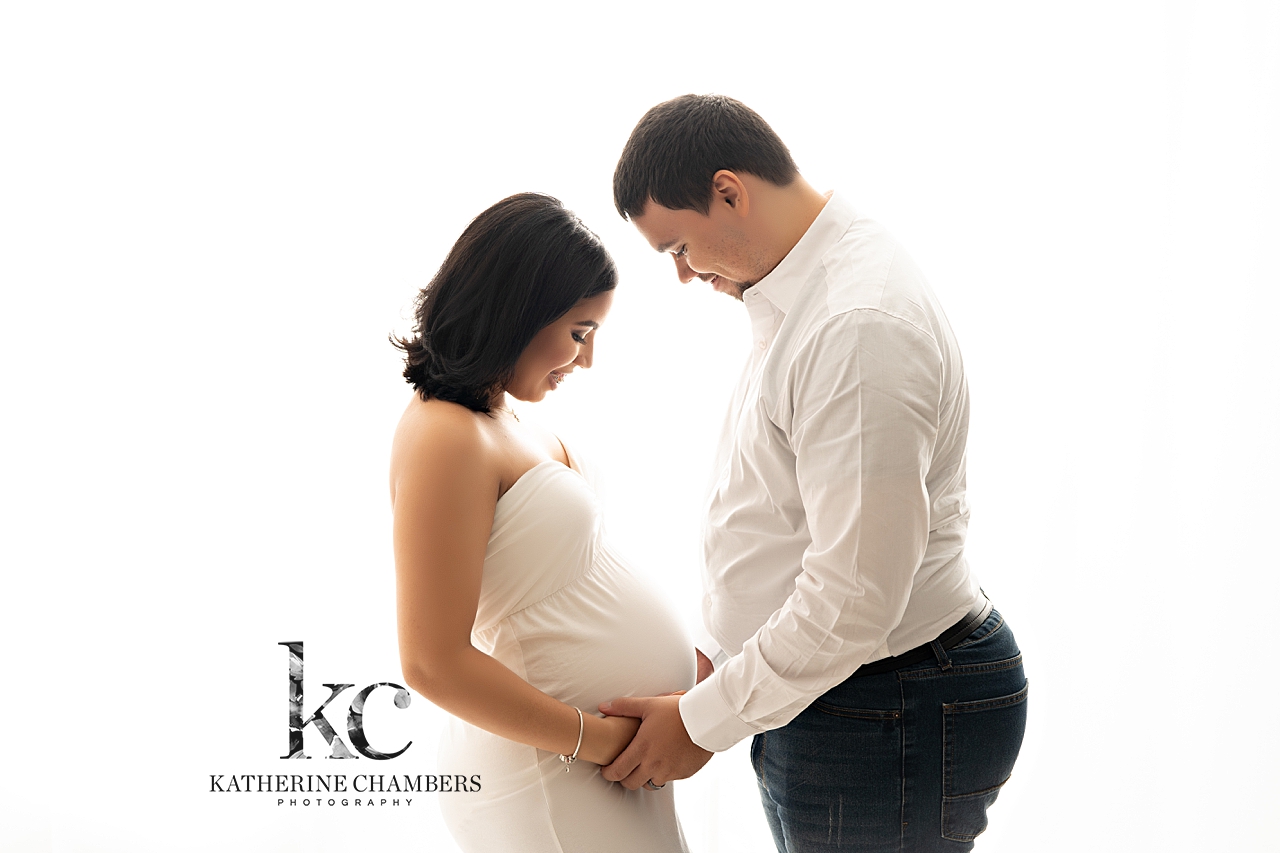 Avon Maternity Photographer | A loving couple gazing at each other during a maternity photo session in Cleveland