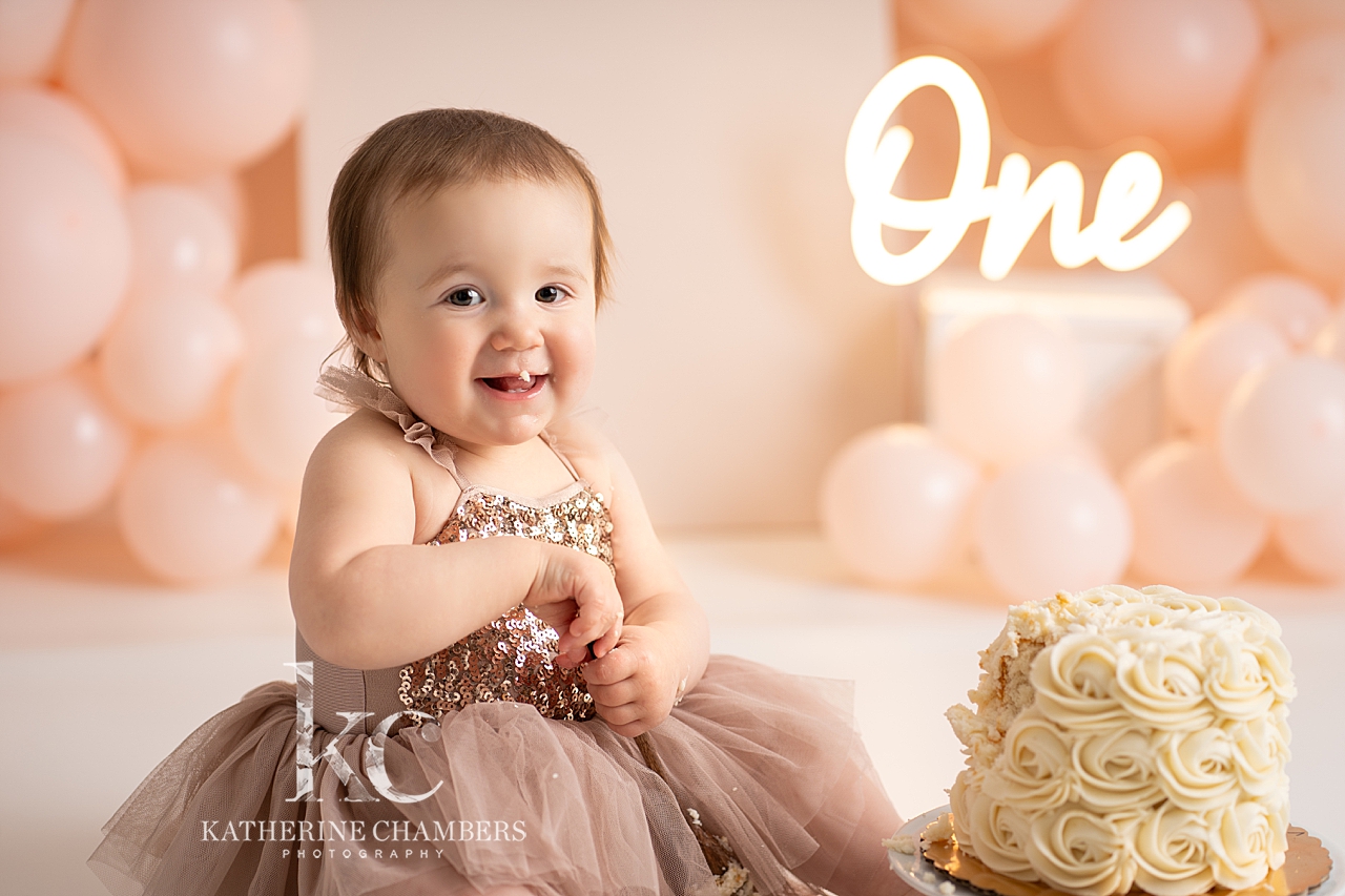 Loving every messy moment of her cake smash!