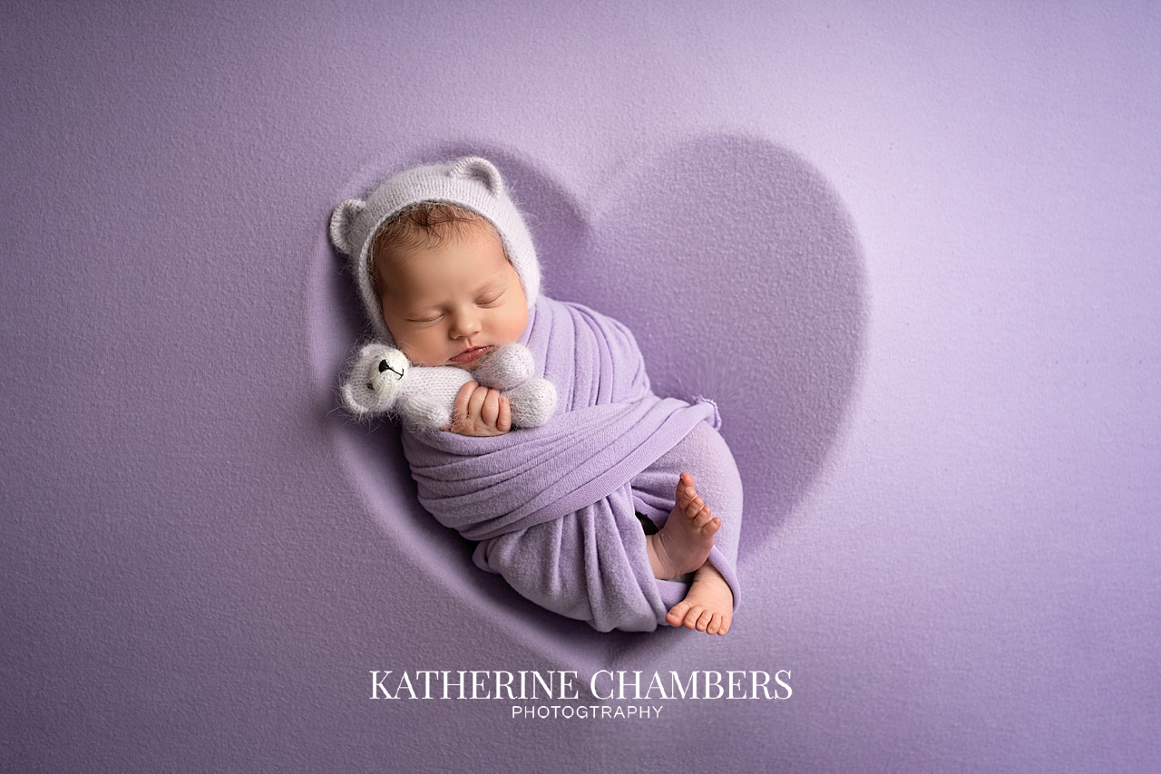 Newborn baby girl Emma wrapped in purple during Cleveland newborn photography session