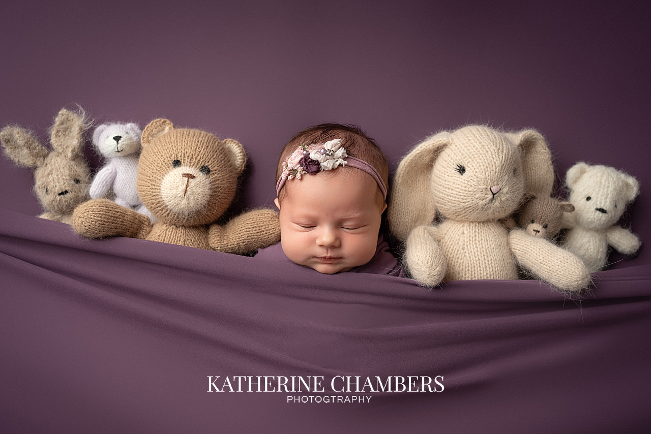 Purple newborn setup for baby girl Emma in Cleveland photography studio