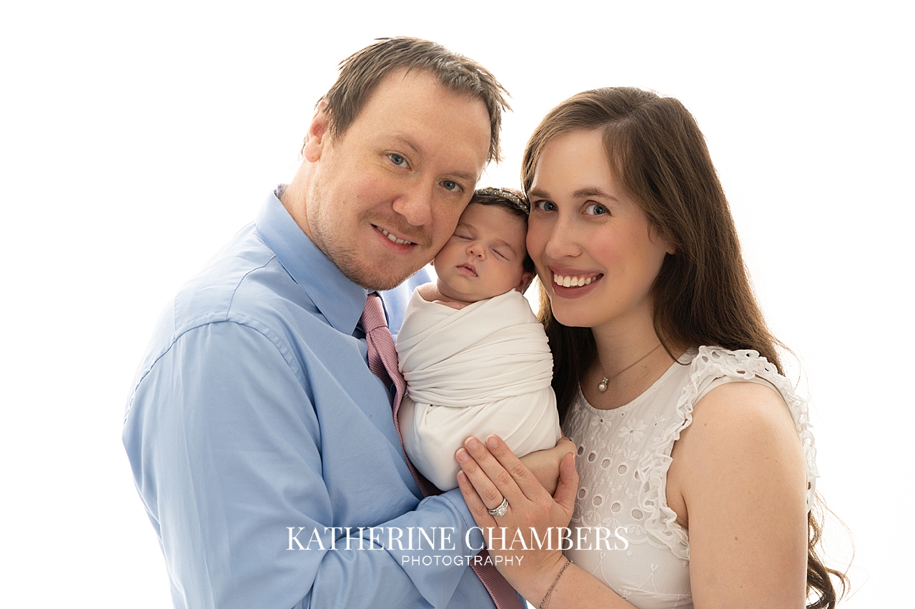 Parents holding newborn baby girl