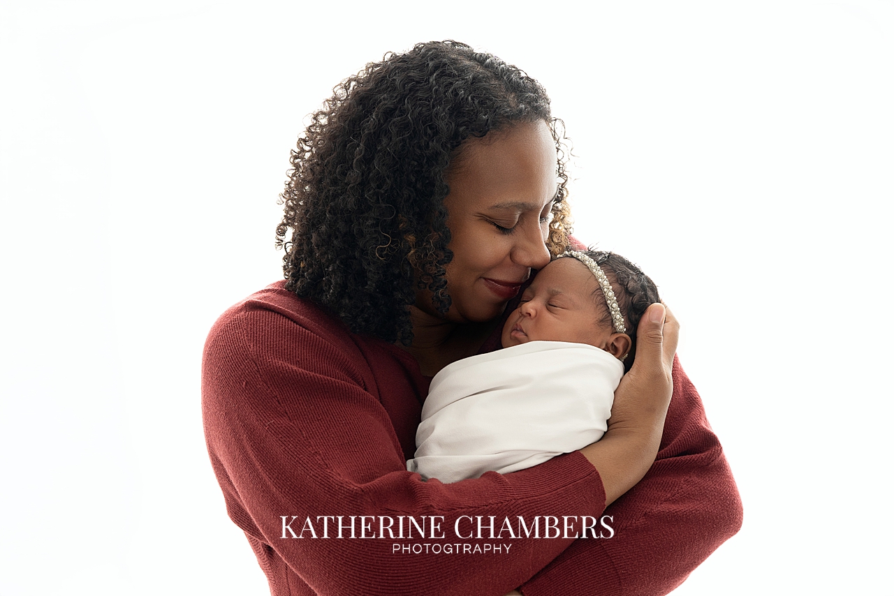 Mother holding her newborn baby girl during studio session in Cleveland