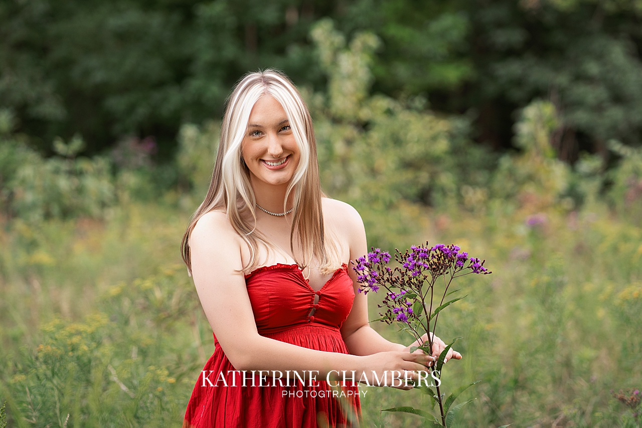 High school senior girl Lizzy standing in a meadow during her Cleveland senior session