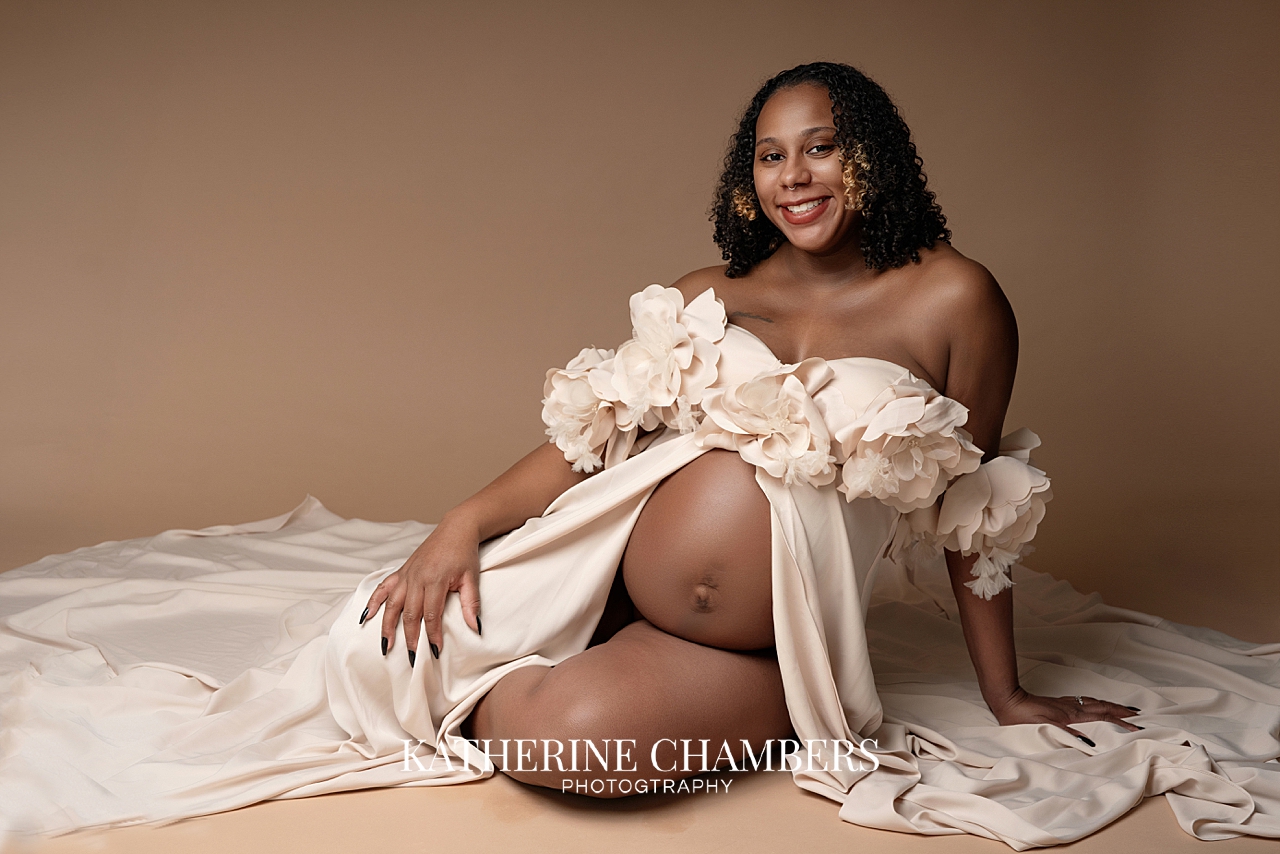 Elegant maternity session with soft flowing fabric dress in Cleveland studio