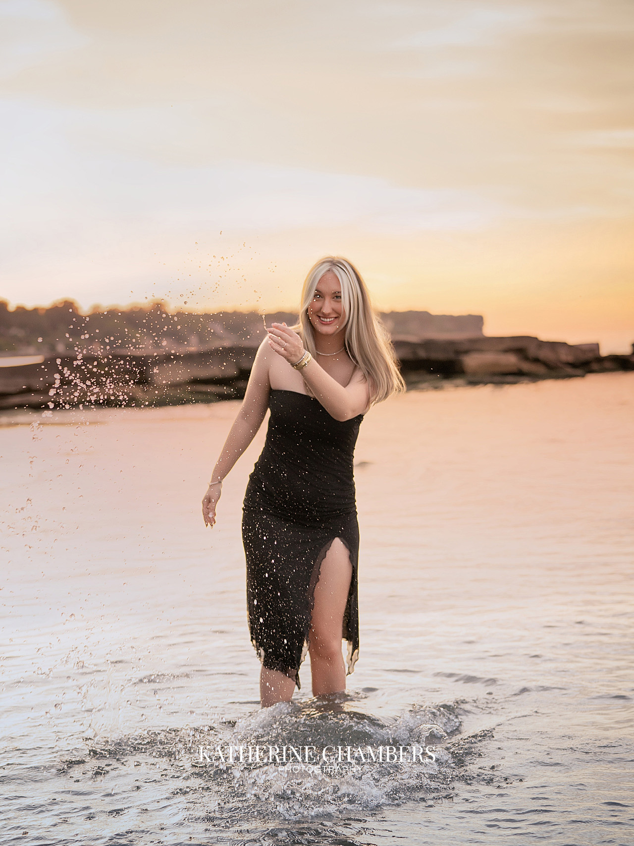 Candid senior portrait of Lizzy playing in Lake Erie at sunset