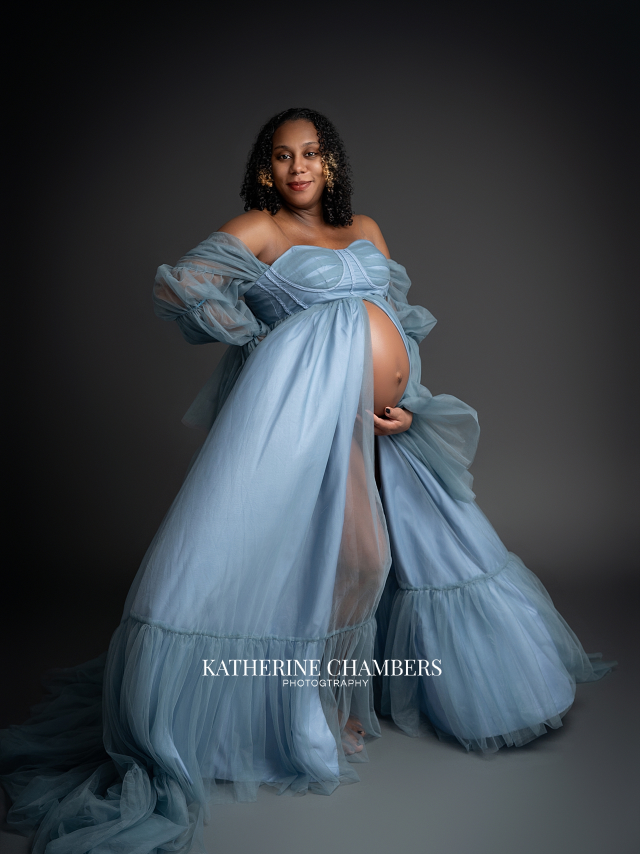 legant maternity portraits with blue flowing dress and soft movement Cleveland photographer