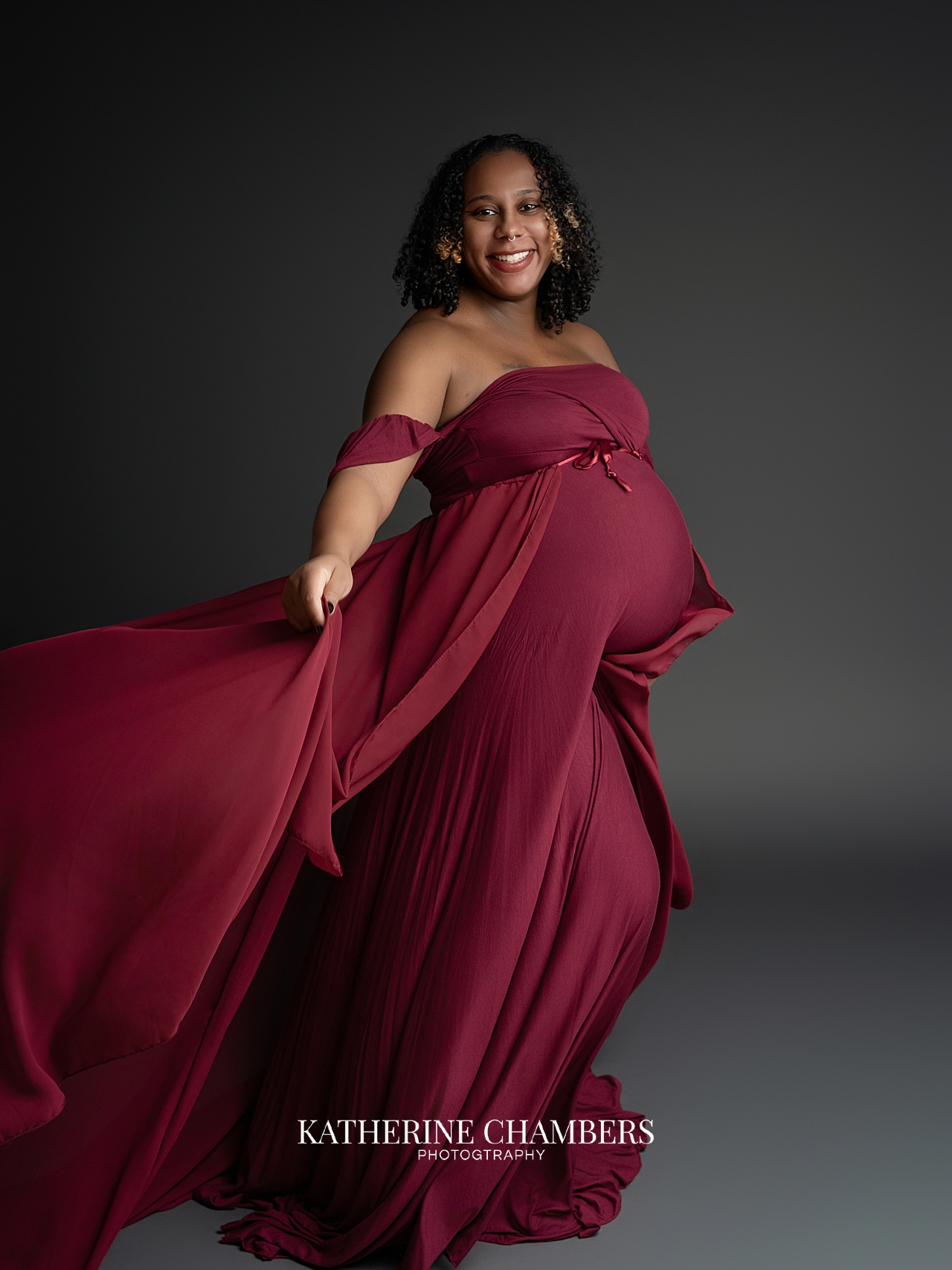 Dramatic maternity portrait with red flowing dress Cleveland maternity photography