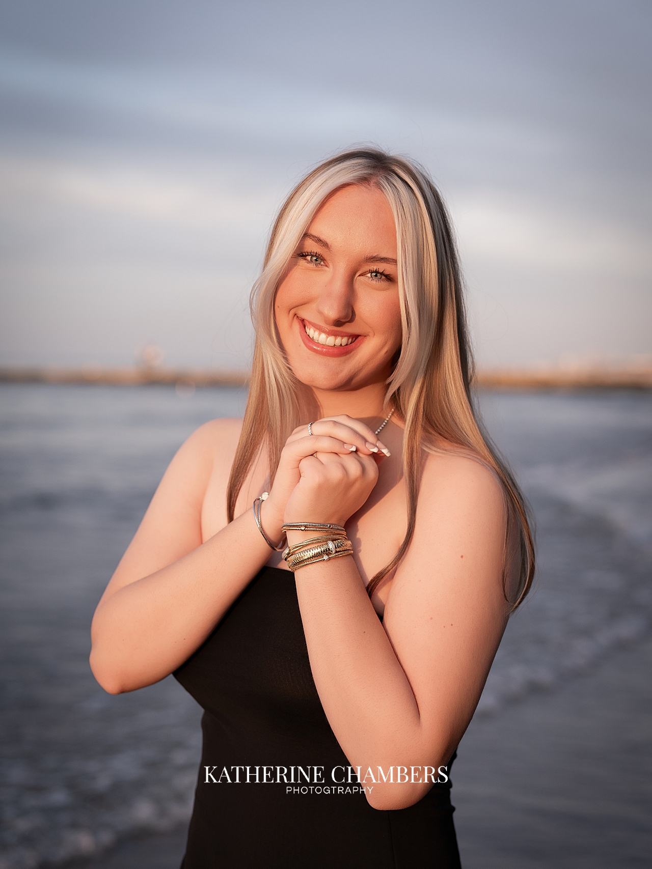 Warm sunset senior photos of Lizzy by the water in Cleveland