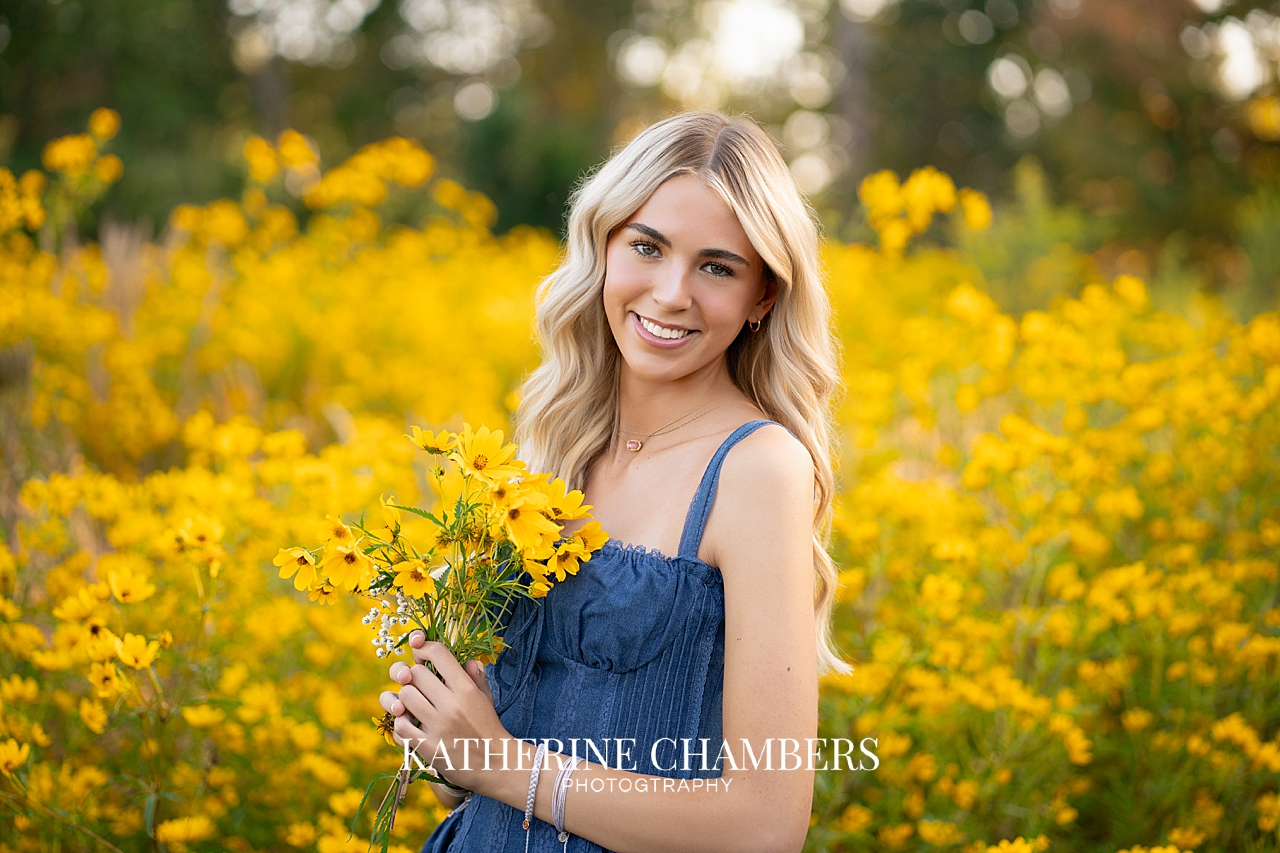 High school senior girl posing in yellow wildflower meadow in Cleveland Ohio