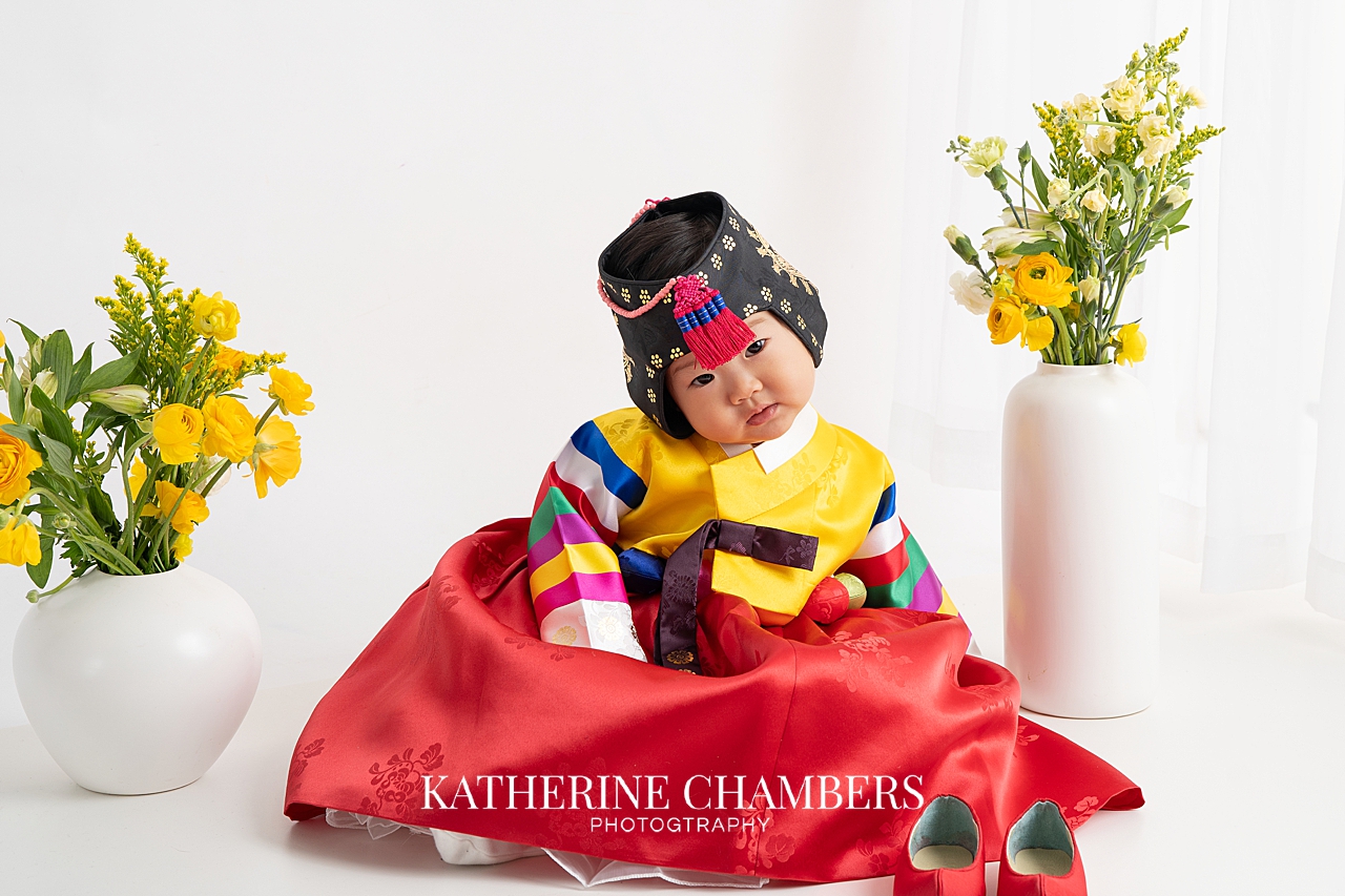 Baby Seren wearing a colorful traditional Korean outfit during her doljabi ceremony