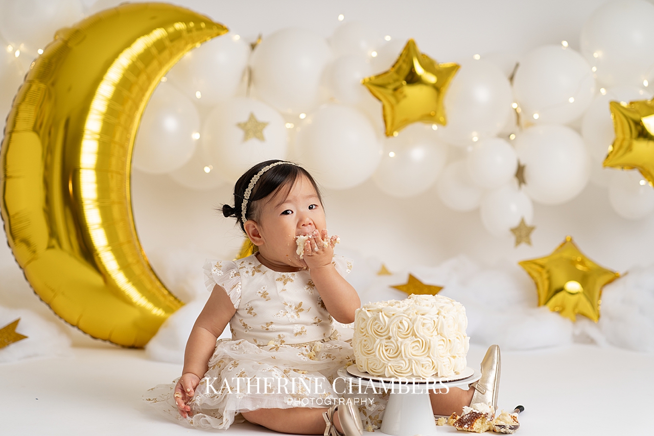 Seren with a fist full of cake during her one year session