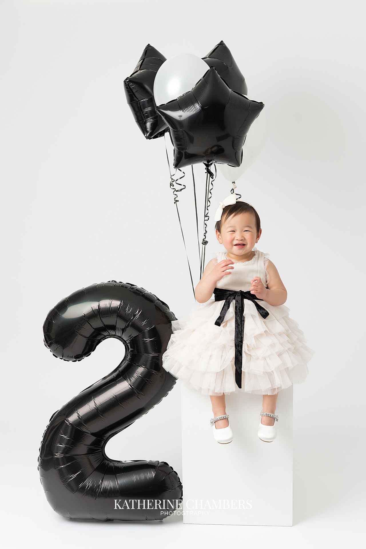 Toddler birthday session with giant number 2 and black and white themed set