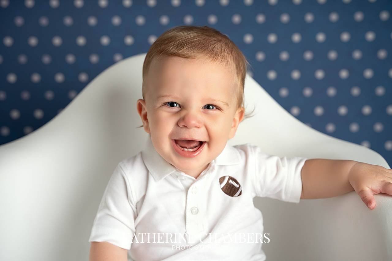 Smiling one year boy PJ | PJ’s First Birthday Football Cake Smash | Cleveland Baby Photographer