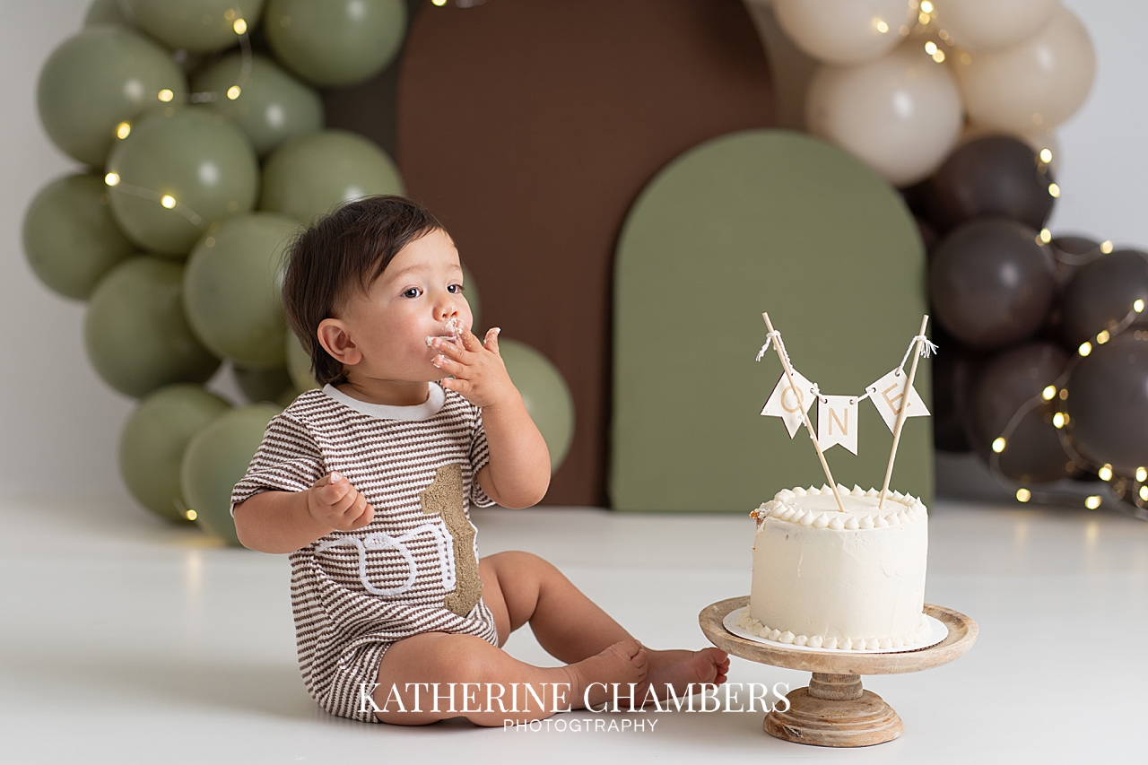 Baby EJ enjoying his first birthday cake