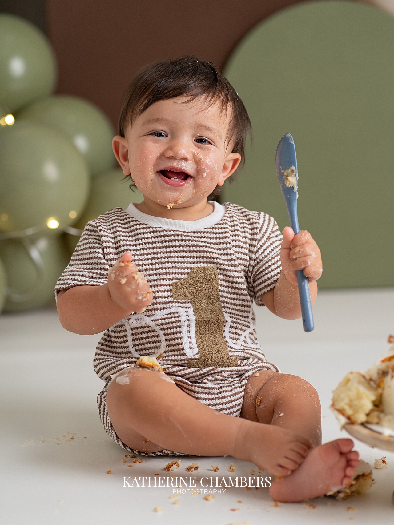 EJ smiling during his first birthday cake smash