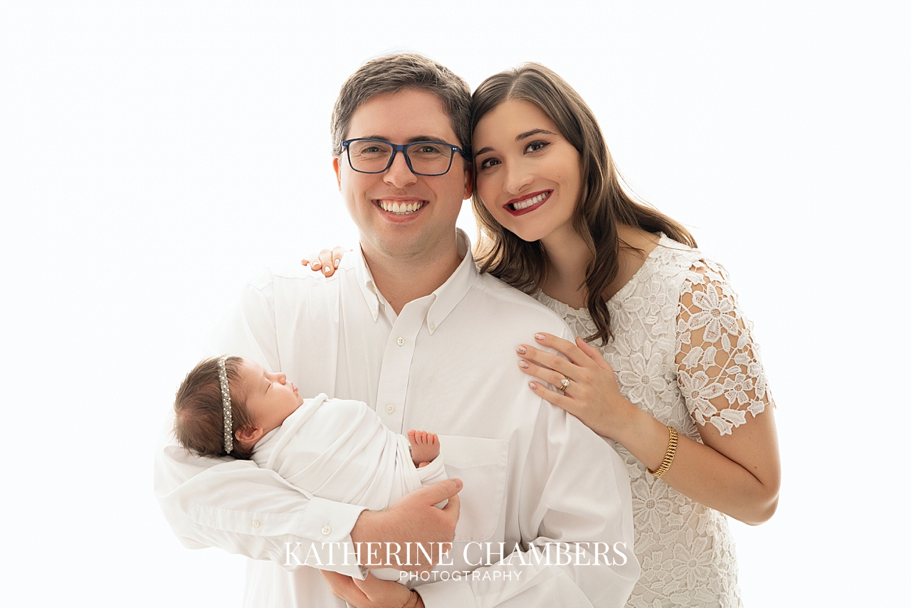 Newborn Lily's with her smiling parents.